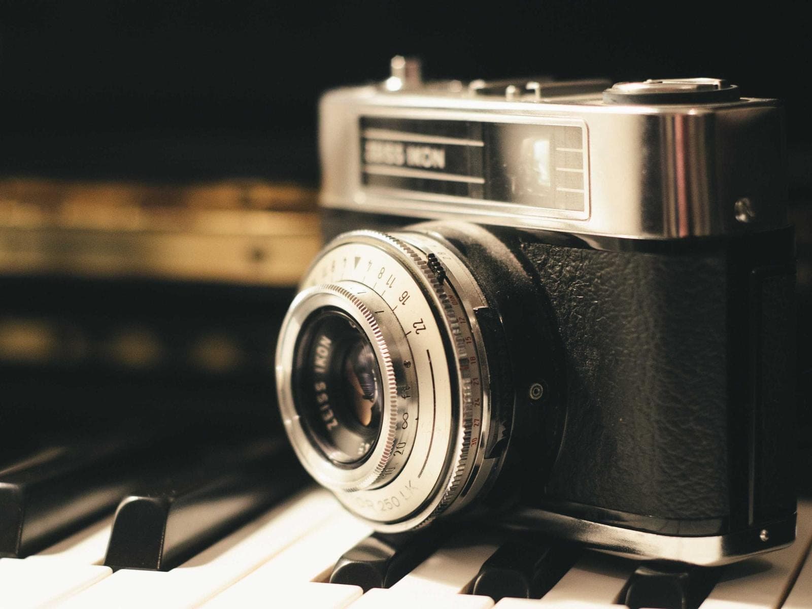 A camera resting on piano keys