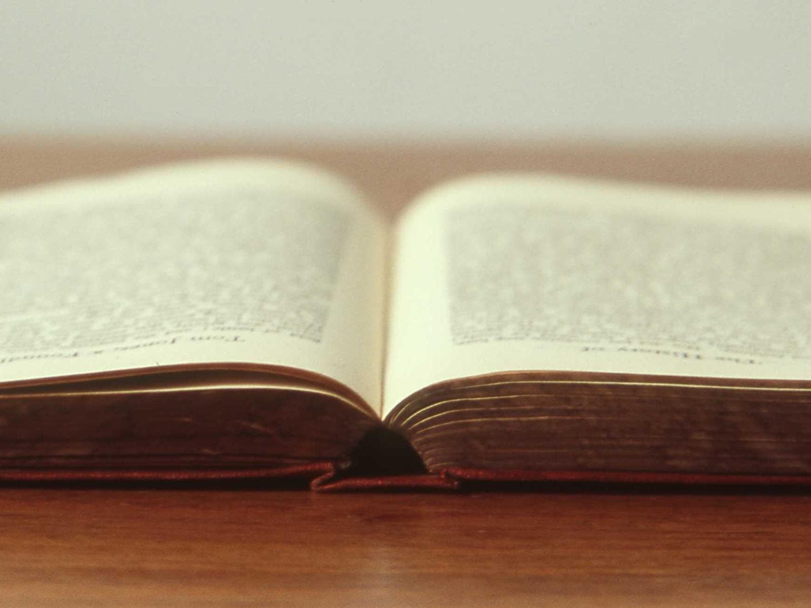 An open book on a wooden desk